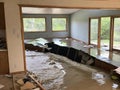 a flooded house with a pile of furniture in the middle of the room