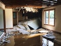 a flooded house with a pile of furniture in the middle of the room