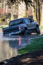 A flooded park with a pickup truck driving through