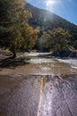 Flooded paved road from recent heavy rainfall in the Gila National Forest of New Mexico on a sunny fall day