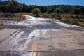 Flooded paved road from recent heavy rainfall in the Gila National Forest of New Mexico on a sunny fall day Royalty Free Stock Photo