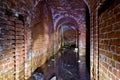 Flooded red brick tunnel under old fortress