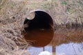 Flooded round sewer pipe with dirty water Royalty Free Stock Photo