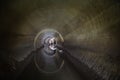 Flooded round sewer tunnel is reflecting in water