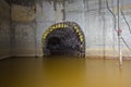 Flooded round underground drainage sewer tunnel with dirty sewage water flowing to collector Royalty Free Stock Photo