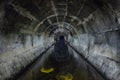 Flooded round underground drainage sewer tunnel reflecting in dirty sewage water Royalty Free Stock Photo