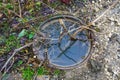 Flooded sewer with an open manhole cover. Background with copy space