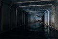 Flooded sewer tunnel is reflecting in water. Dirty urban sewage flowing throw rectangular sewer tunnel