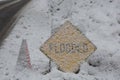 Flooded Sign Covered in Fresh Snow During Warm Winter Storm Royalty Free Stock Photo