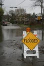 Flooded sign sits on a flooded street