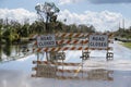 Flooded street in Florida after hurricane rainfall with road closed signs blocking driving of cars. Safety of Royalty Free Stock Photo