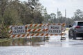 Flooded street in Florida after hurricane rainfall with road closed signs blocking driving of cars. Safety of Royalty Free Stock Photo