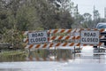 Flooded street in Florida after hurricane rainfall with road closed signs blocking driving of cars. Safety of Royalty Free Stock Photo