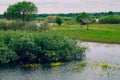 Flooded trees and meadows, wooden building on the background of the wild nature of Belarus,