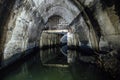 Flooded underground urban sewer tunnel. Large sewage collector