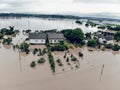 Flooded village on Ukraine. Natural disaster in Halych. Street with trees and houses in dirty river water