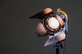 Floodlight with halogen lamp and Fresnel lens on a gray background. Lighting equipment for shooting Royalty Free Stock Photo