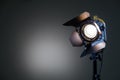 Floodlight with halogen lamp and Fresnel lens on a gray background. Lighting equipment for shooting Royalty Free Stock Photo