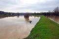 Floodwaters inundate fields after a river breaches its banks