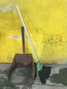 Floor broom scrapes yellow wall trash