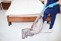 Floor care and cleaning services with vacuume cleaner at hotel room