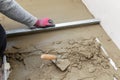 Floor construction - man leveling concrete screed Royalty Free Stock Photo