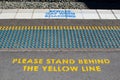 Floor Dots to help blind people finding their way and warning signs `Please stand behind the yellow line and beware gap when board