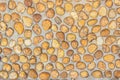 Floor gravel pebble stone on concrete wall background or fence texture made of a close up of medieval stone walls with colorful Royalty Free Stock Photo