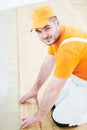 Worker joining parquet floor. Royalty Free Stock Photo
