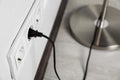 Floor lamp plugged into wall power socket indoors, closeup. Space for text Royalty Free Stock Photo