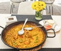 Typical Spanish paella one dish with homemade garlic and fresh tomato sauce