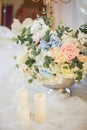 Floor metal vase with flowers and white candles.Romantic atmosphere Royalty Free Stock Photo