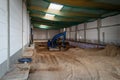 the floor of a newly built factory hall is excavated with an excavator Royalty Free Stock Photo