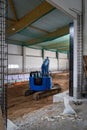 the floor of a newly built factory hall is excavated with an excavator Royalty Free Stock Photo