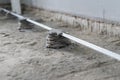 Floor repair, installation of guides for concrete screeds. Installation of a level for pouring concrete. Royalty Free Stock Photo