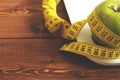 Floor scales, tape measure and green apple on a wood background top view. The concept of a healthy diet, body weight Royalty Free Stock Photo