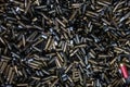 On the floor in the shooting range there are casings from fired cartridges of various calibers - from pistols, assault rifles, Royalty Free Stock Photo