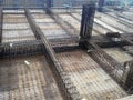 Floor slab and beam reinforcement bar under fabrication at the construction site by workers.