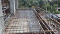 Floor slab and beam reinforcement bar under fabrication at the construction site by workers.