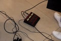 Guitar pedal control. On the floor. There`s a guitarist nearby. We`ve had his legs in sneakers and wires