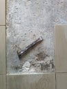 Floor tile removal. Old tools on floor. Dismantling old floor tiles. Renovations. Chisel on concrete slab. Very old Royalty Free Stock Photo