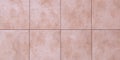 Floor tiles texture, abstract pattern of squares with pink ceramic tile. Marble wall background, wallpaper. Light brown wide Royalty Free Stock Photo