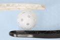 Floorball stick and white ball