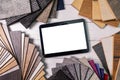 Flooring and furniture materials - floor carpet and wooden laminate samples with blank digital tablet