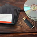 Floppy disks, USB flash drive and disks on a wooden background Royalty Free Stock Photo