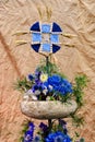 Floral arrangement of blue flowers, stone and pine branches on a crumpled paper background