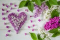 Floral arrangement of lilac flowers and heart made of lilac petals