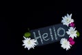 Floral arrangement with a sign with hello inscription in chalk