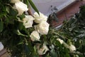 Floral arrangement of white roses and fresh branches