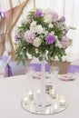 Floral arrangements on white pillars stand on the tables in the restaurant Royalty Free Stock Photo